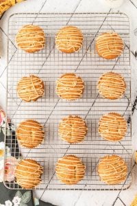 cooling rack with 1 dozen banana muffins with homemade caramel frosting drizzled on top
