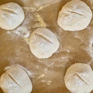 shaped sourdough rolls on parchment