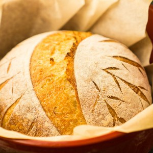 round loaf of bread in red dutch oven