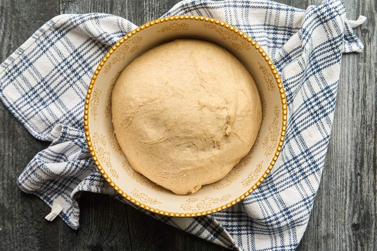 fully risen dough in mixing bowl.
