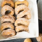 a dozen apple cider doughnuts in white box lined up