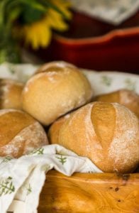 4 wheat rolls in wooden bowl