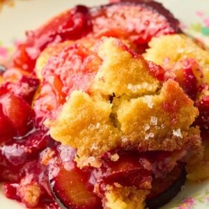 close up view of plated plum cobbler.