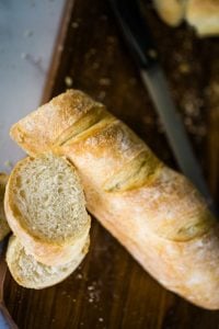 sliced sourdough baguette on cutting board