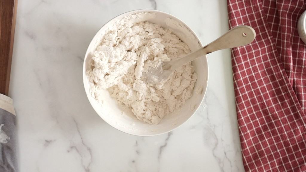 mixing bowl with ingredients for sourdough pizza dough that needs a little more water