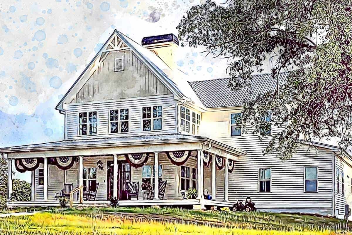 white farmhouse with windows and red white and blue bundting