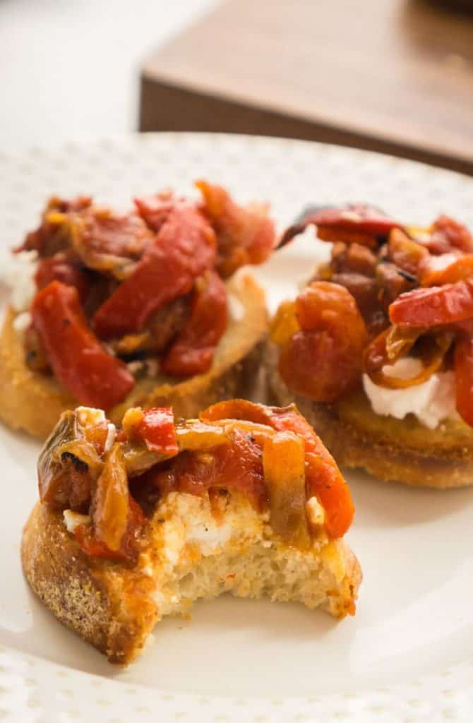 3 round toasts with goat cheese and roasted peppers