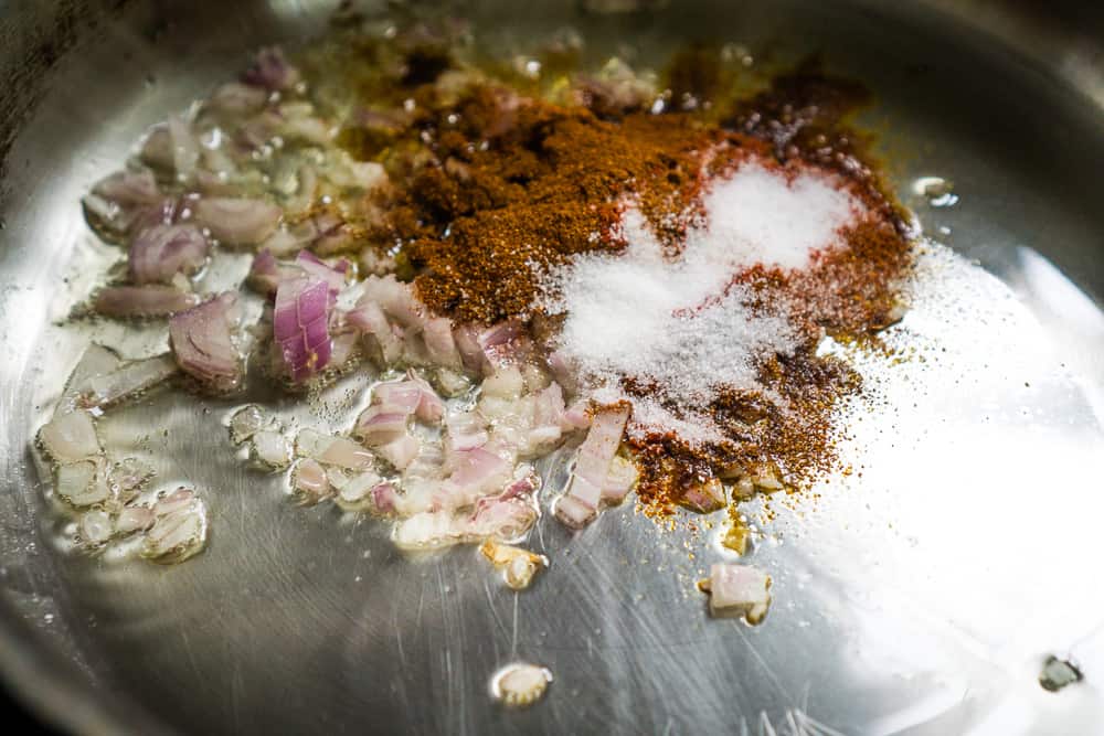 stainless pan with shallots, olive oil, smoked paprika, and other seasonings