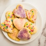 heart shaped rolled sugar cookies on white plate