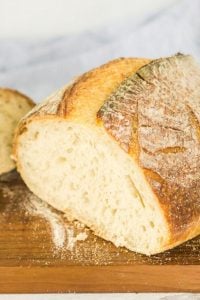 loaf of sourdough made in bread machine on cutting board