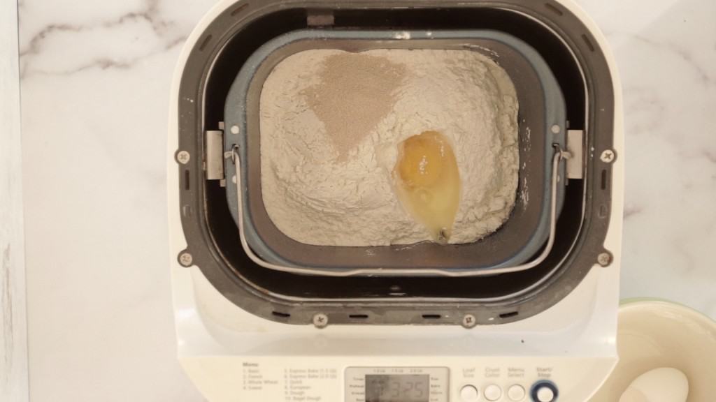 bread machine overhead view with roll ingredients inside