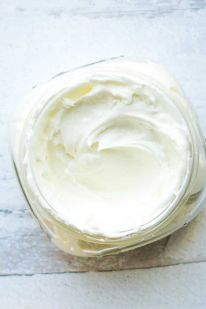 jar of cream on white wood surface