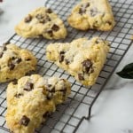 five scones on wire cooling rack with big chocolate chips and coarse sugar