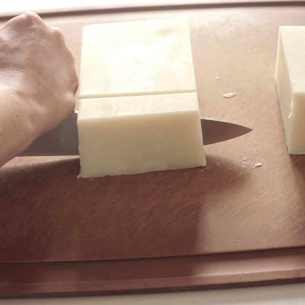 cutting loaf of finished baby soap. into. bars