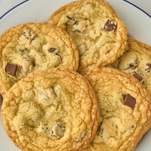 5 giant chocolate chunk cookies on white plate