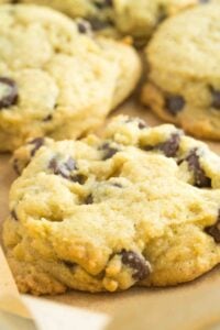 parchment lined baking sheet with finished chocolate chip cookies.