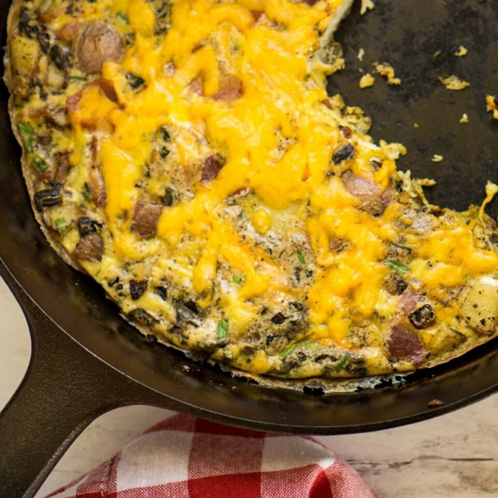 Scrambled egg in small cast-iron skillet. Making omelet eggs. Stock Photo  by ©boomeart 327353544