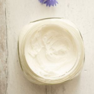 jar. showing white homemade body cream