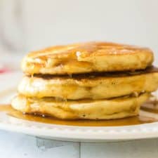 stack of 3 sourdough pancakes on white plate