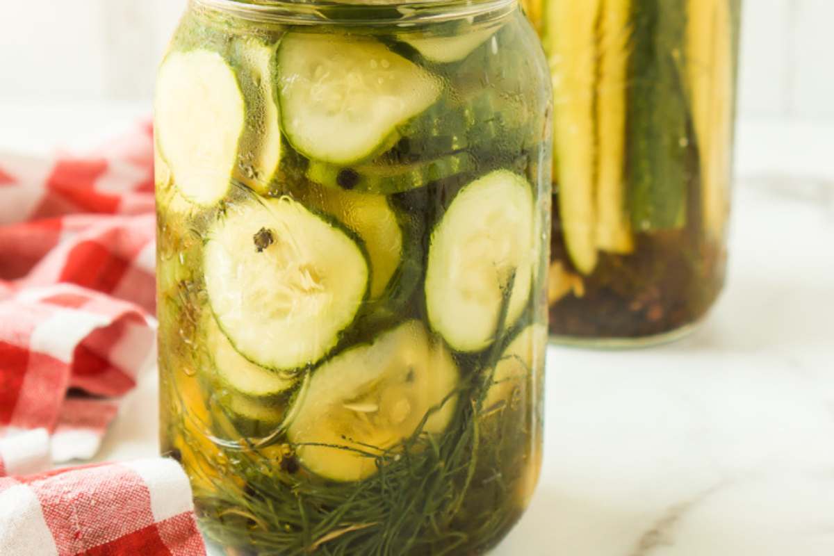 closeup view of sliced homemade pickles in jar.
