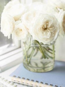 2 planners stacked with vase of flowers