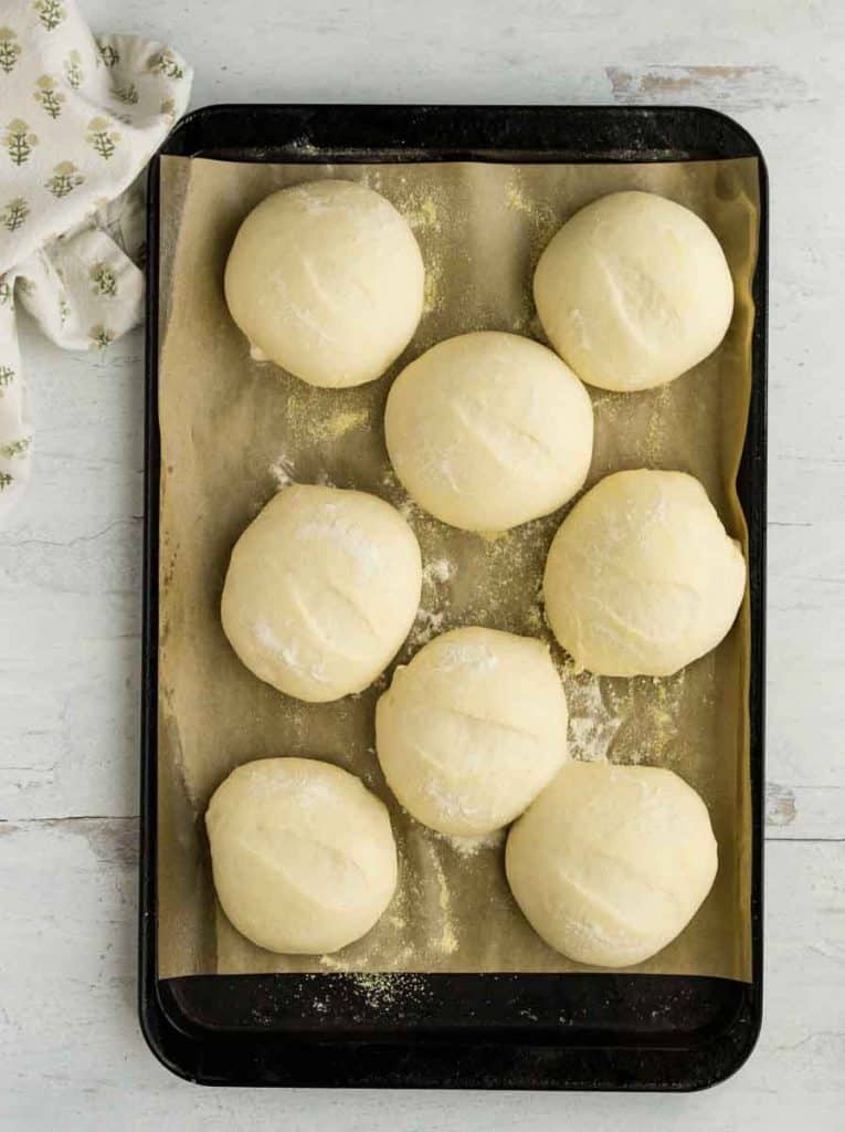 fully risen rolls on baking sheet
