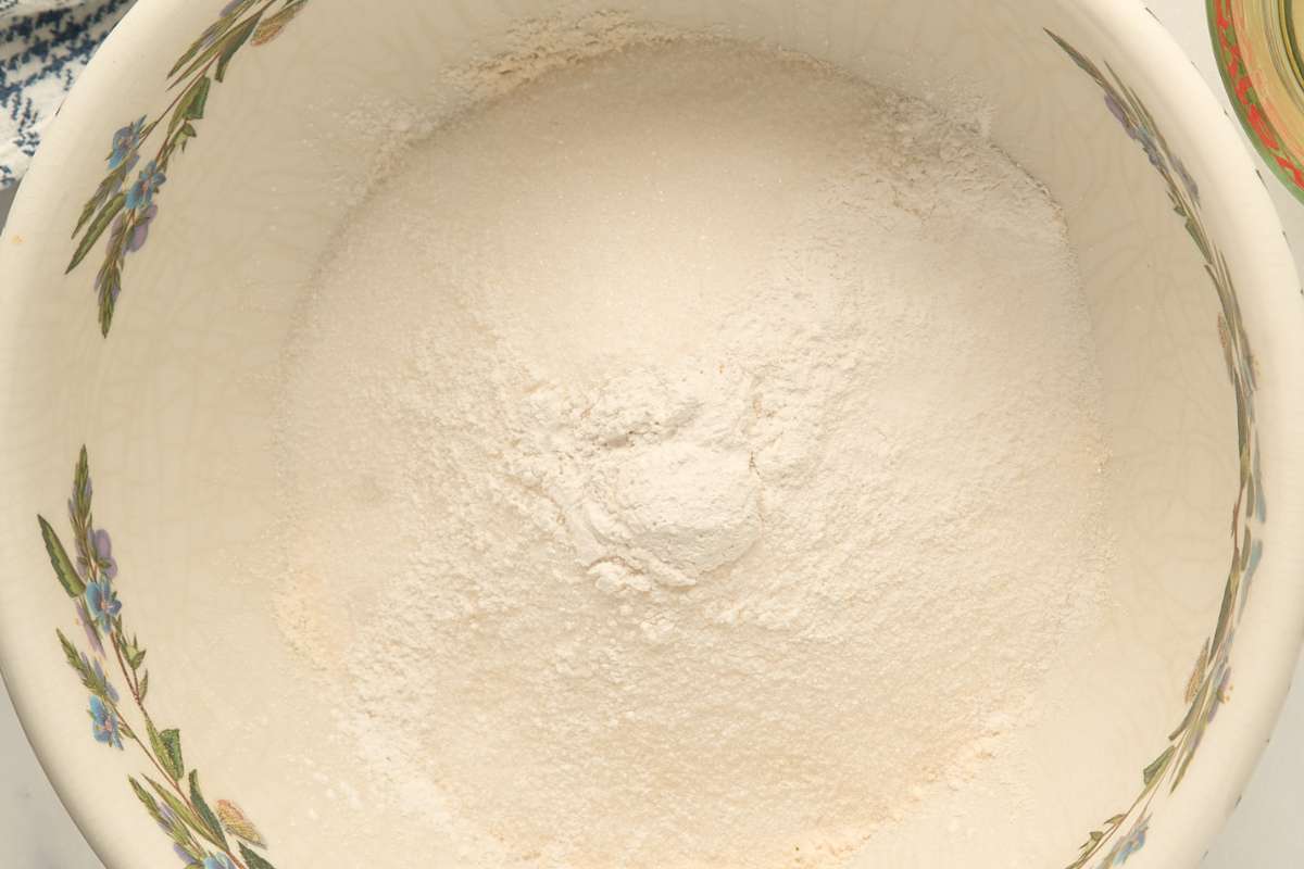 Bowl of mixed dry ingredients including flour and sugar.