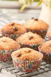 Baked muffins with sugar topping in colorful paper liners.