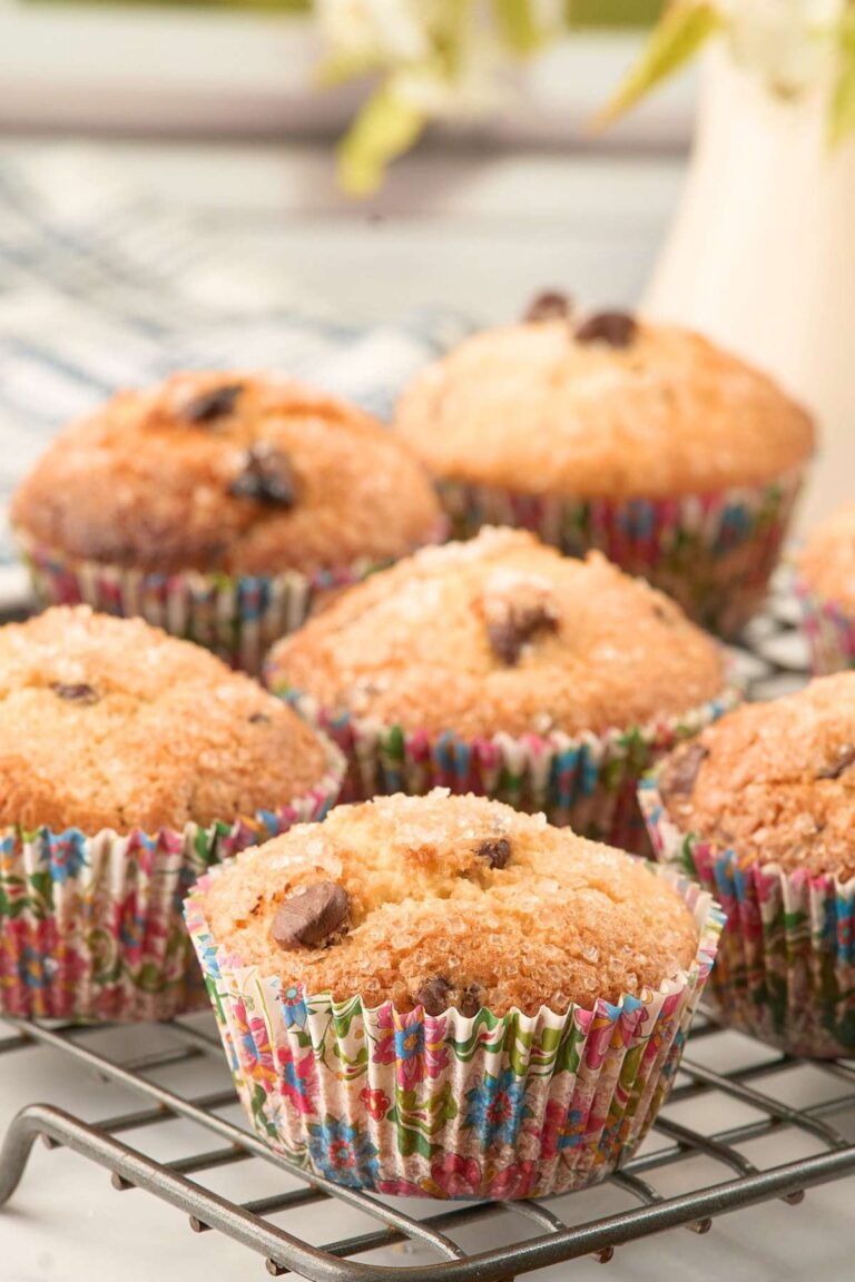 Baked muffins with sugar topping in colorful paper liners.