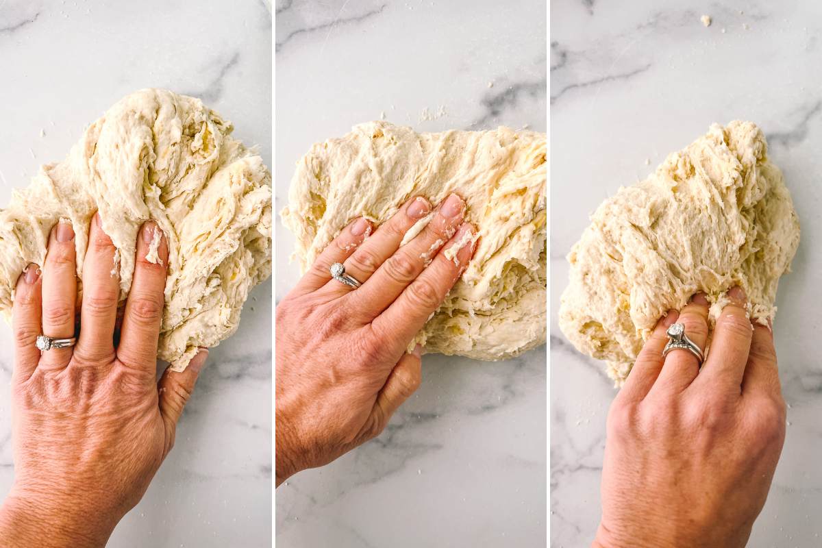 hand kneading dough on counter.