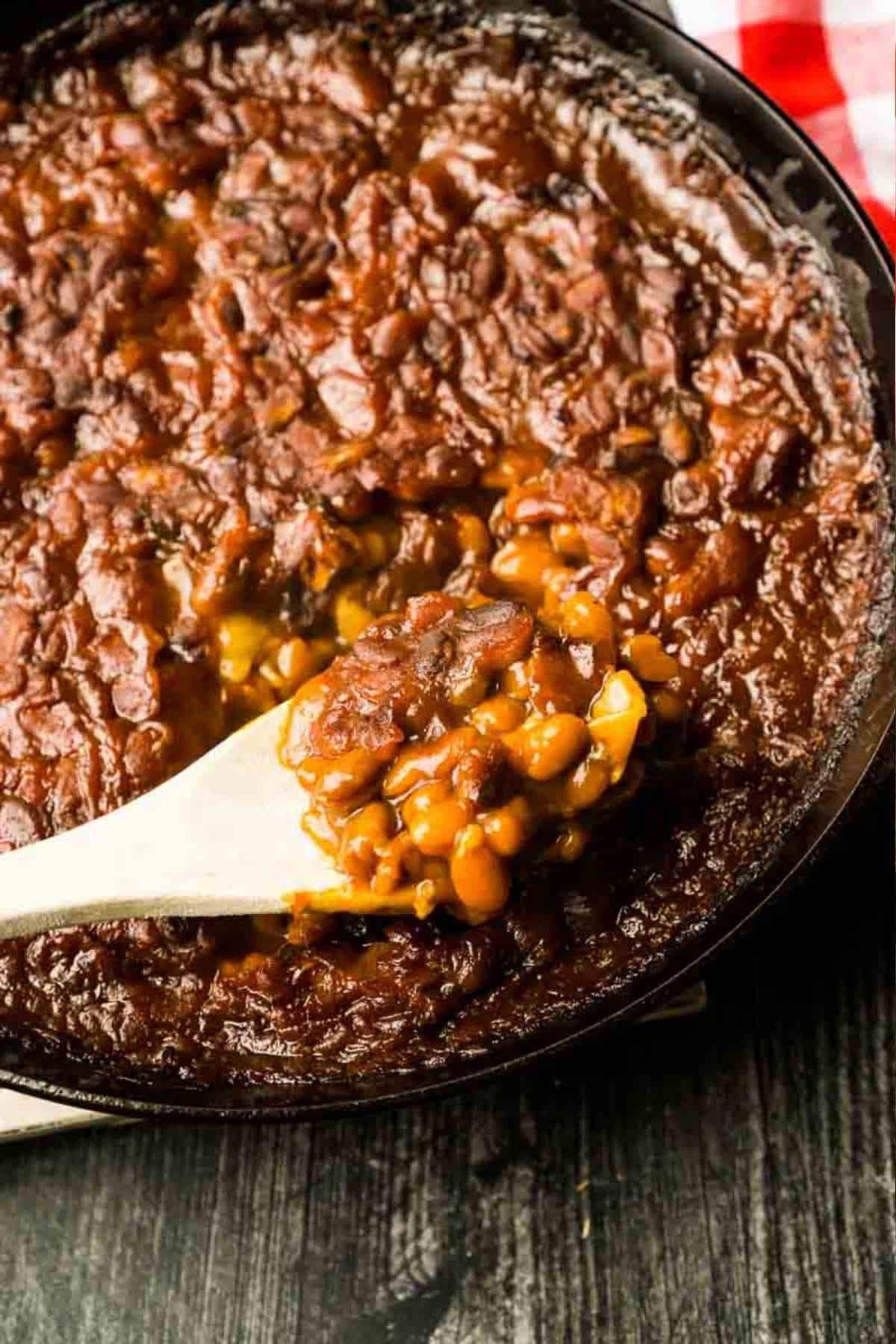 scoop of baked beans in cast iron skillet