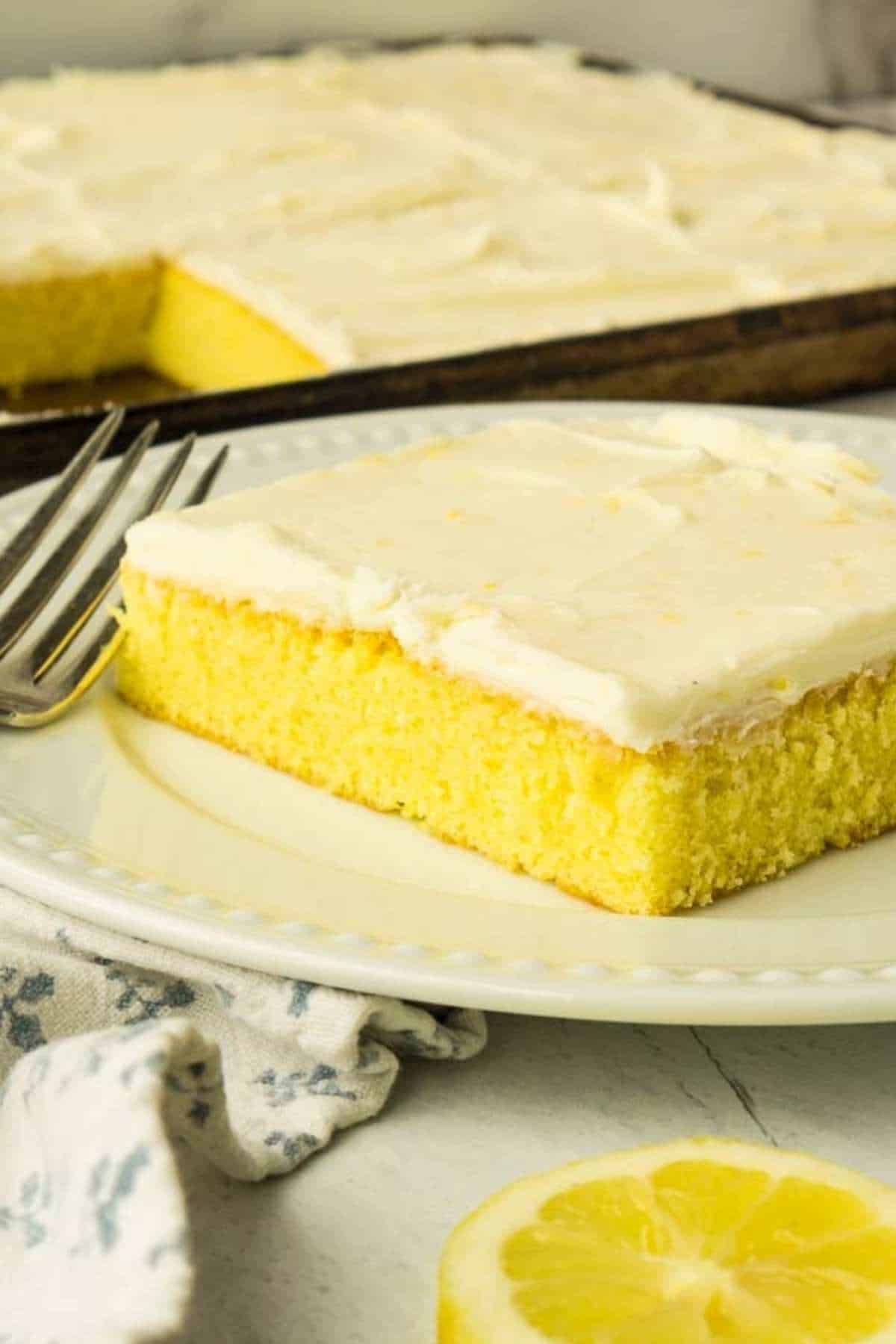 square piece of lemon sheet cake on white plate