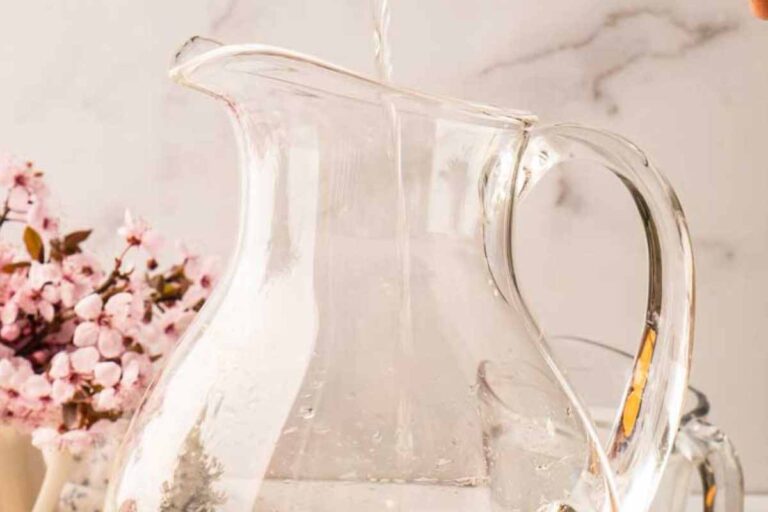 pouring vodka into pitcher.