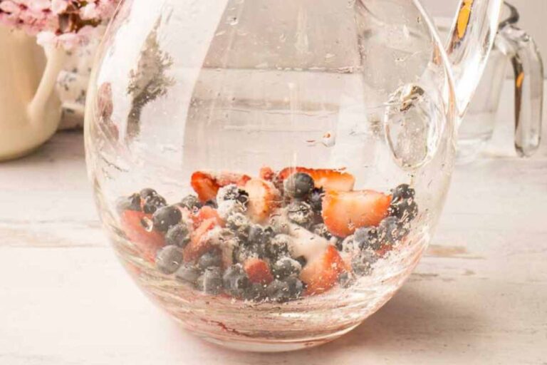 sugared berries in glass pitcher.