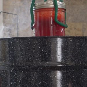 canning tool removing finished lemonade