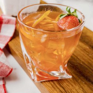 old fashioned with ice and fresh strawberry on top
