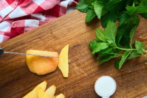 slicing peaches on cutting board.