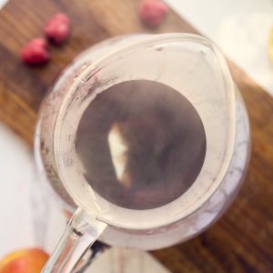 glass pitcher with tea bags and hot water