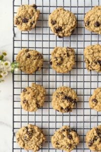 cooling rack of cookies next to wildflower vase