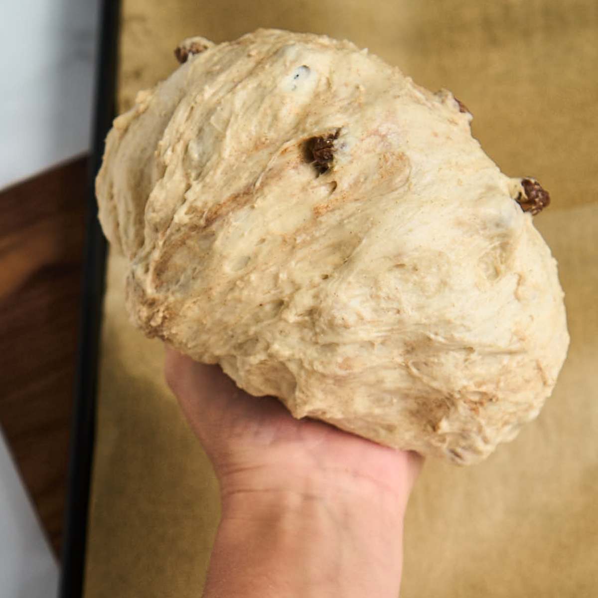 hand stretching dough into a ball
