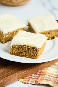 3 square pieces of sourdough pumpkin cake on white plate.