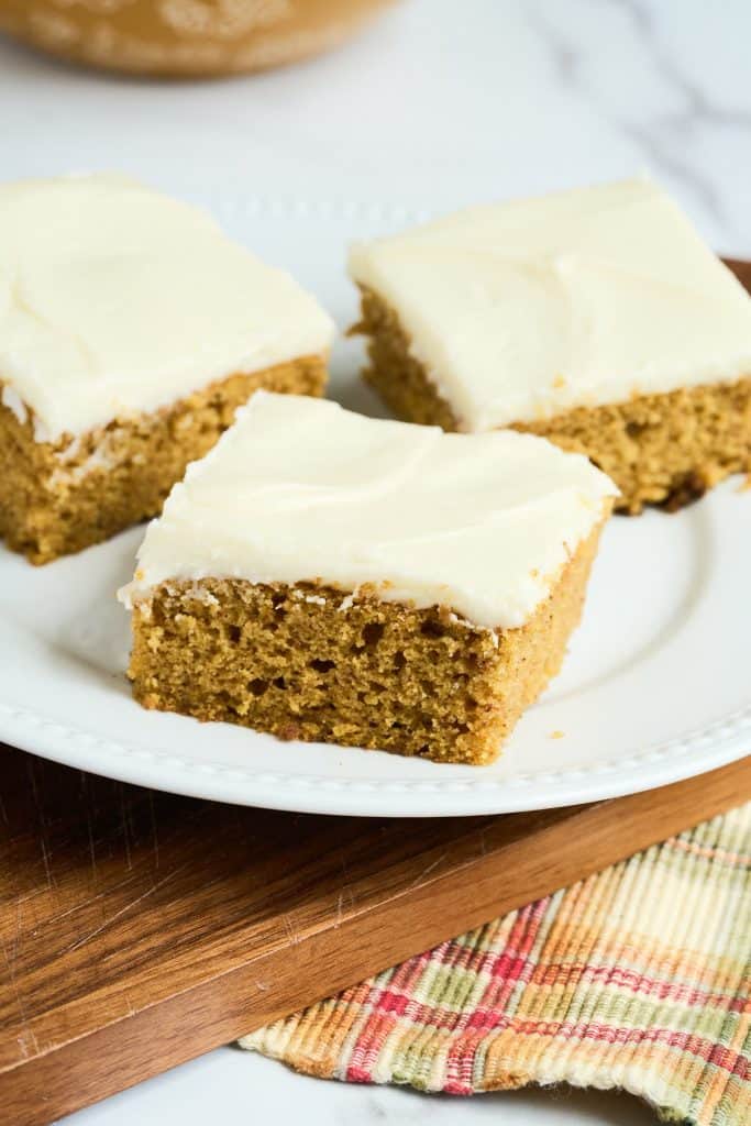 3 square pieces of sourdough pumpkin cake on white plate