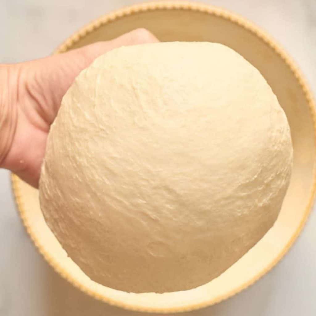 ball of dough in hand