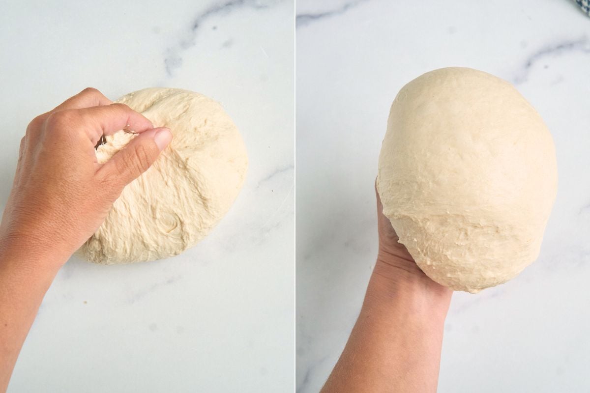 Dough being shaped by hand into a ball.