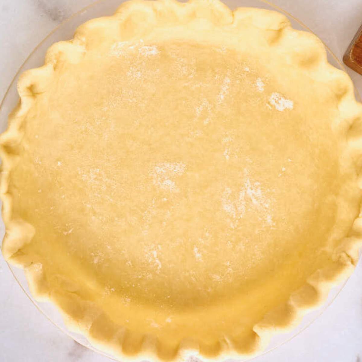 crimped pie crust in dish before baking.
