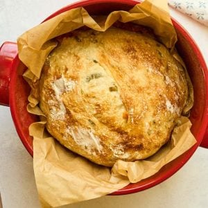 dutch oven with loaf of spiccy cheese no knead bread