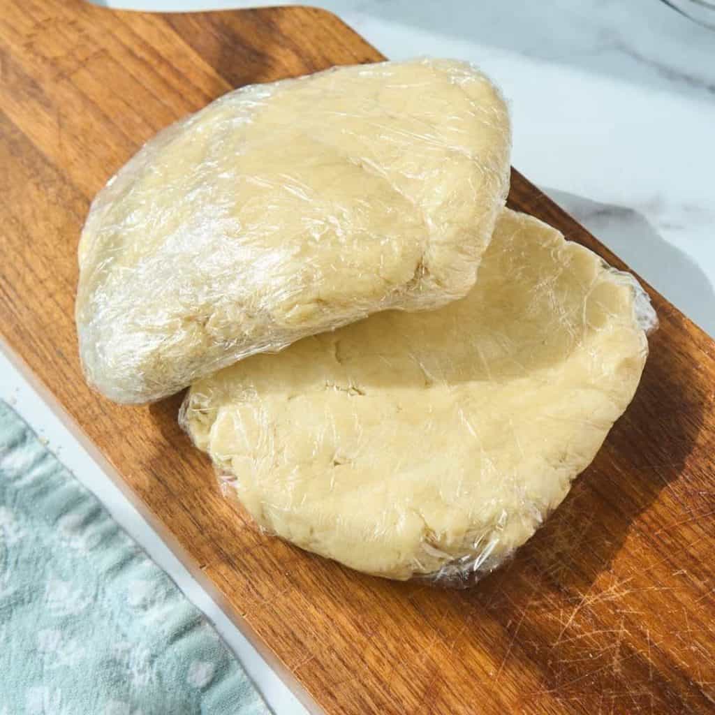 round portions of pie crust wrapped for chilling