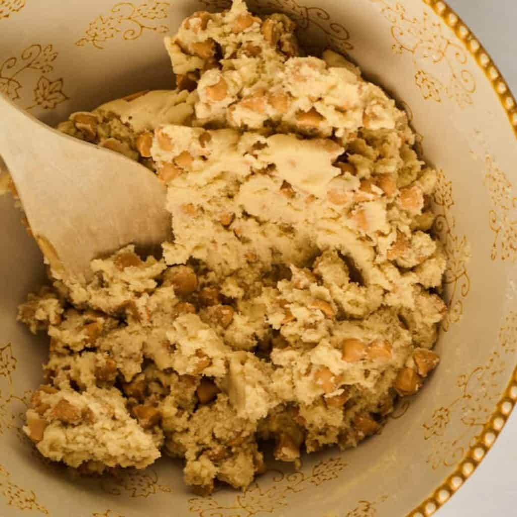 wooden spoon mixing in butterscotch chips