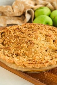 crumb topped apple pie on wooden board