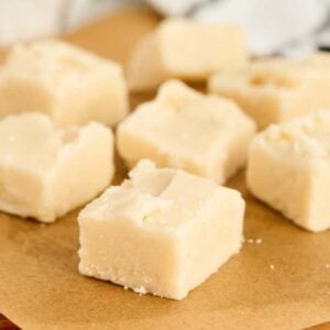 cut squares of vanilla fudge on parchment.